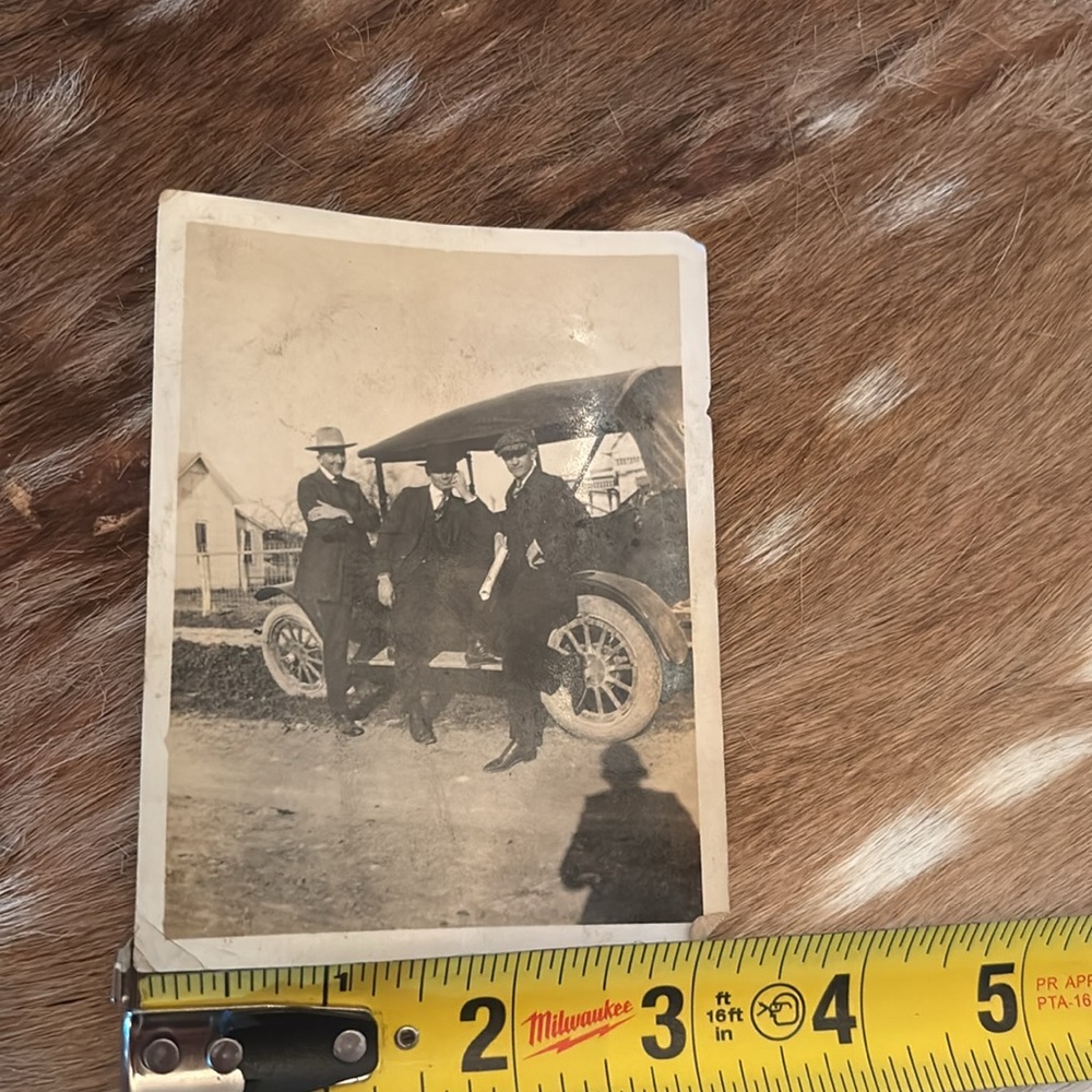 Antique photo of three handsome men hanging out by an old car